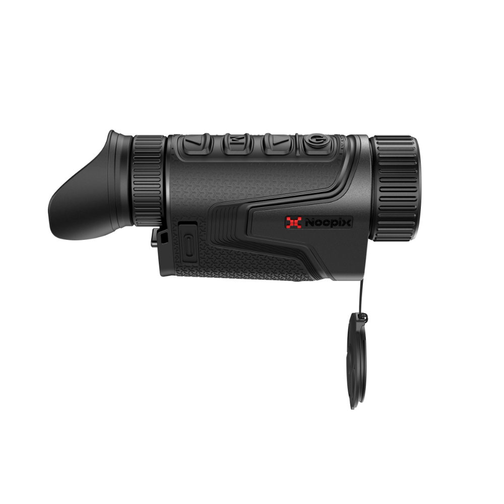 A thermal monocular rifle scope with its protective cap hanging from a lanyard