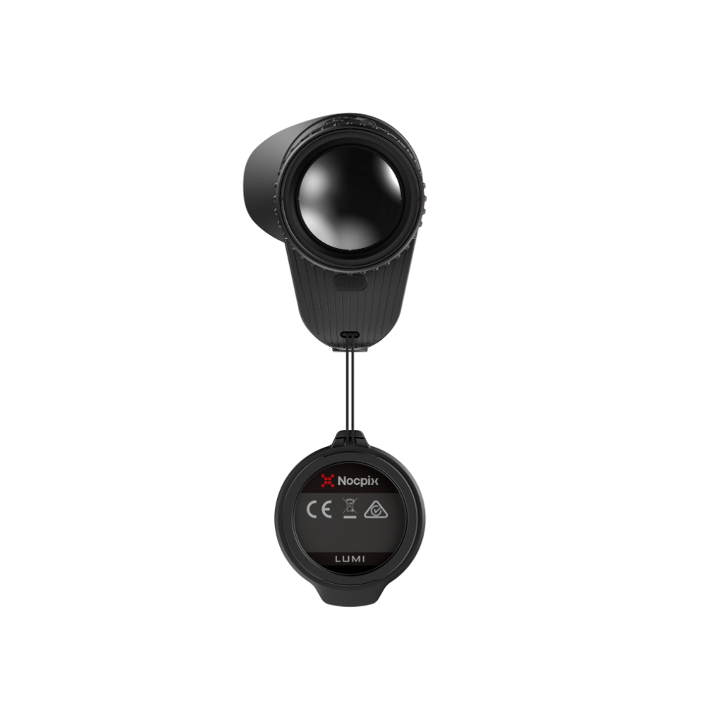 A thermal monocular rifle scope with its protective cap hanging from a lanyard