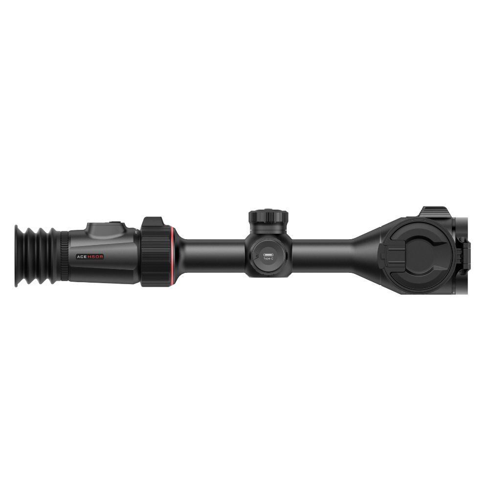 A black rifle scope with illuminated side housing and adjustment knobs, shown horizontally.