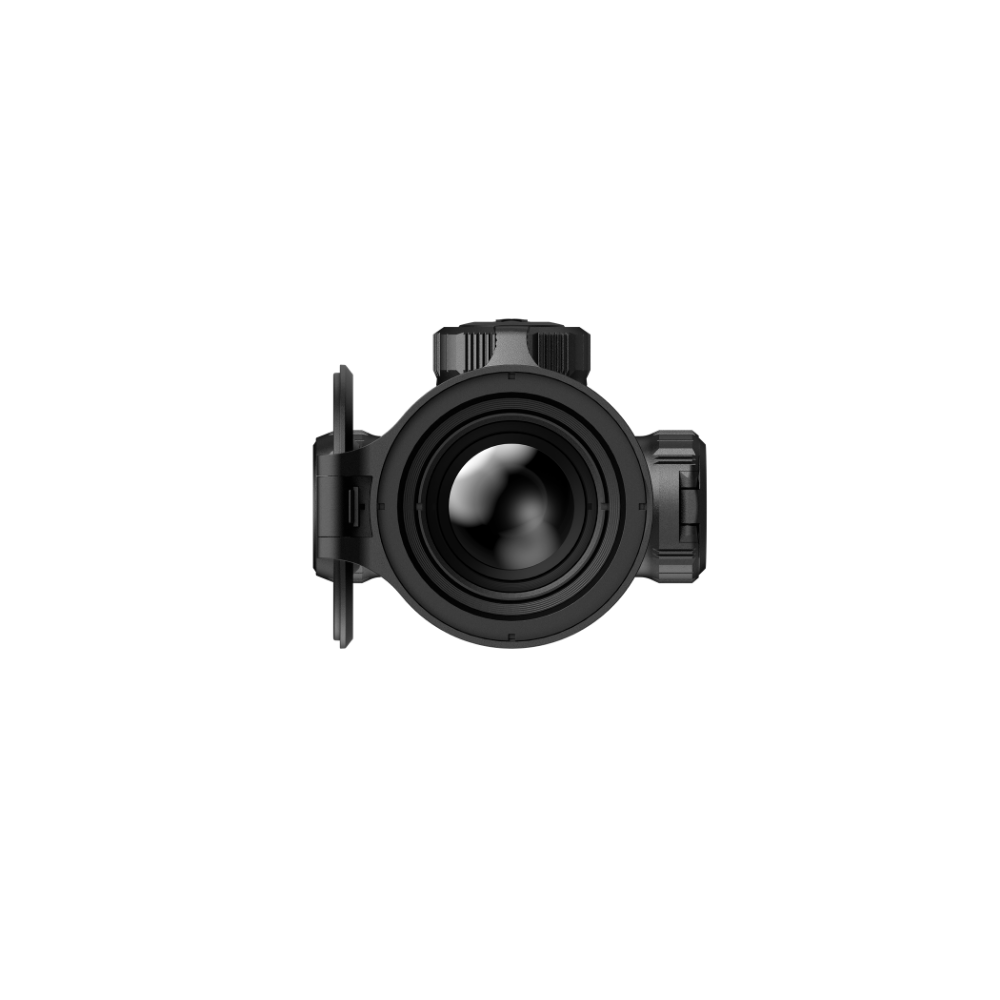 A black rifle scope with a hinged flip-up cover, shown from the front.